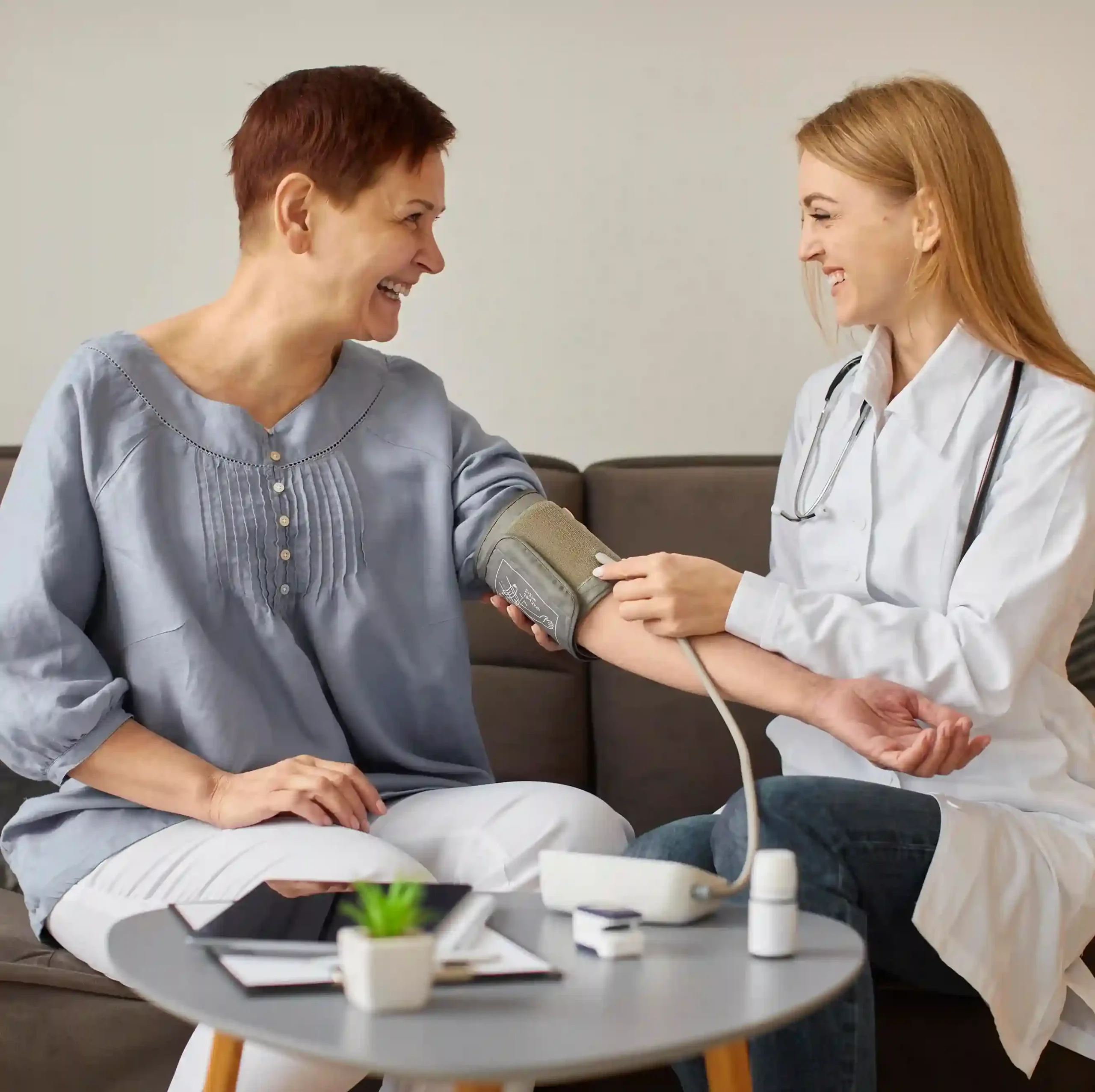 Female doctor checking an elderly patient's blood pressure at a recovery center in Dallas.