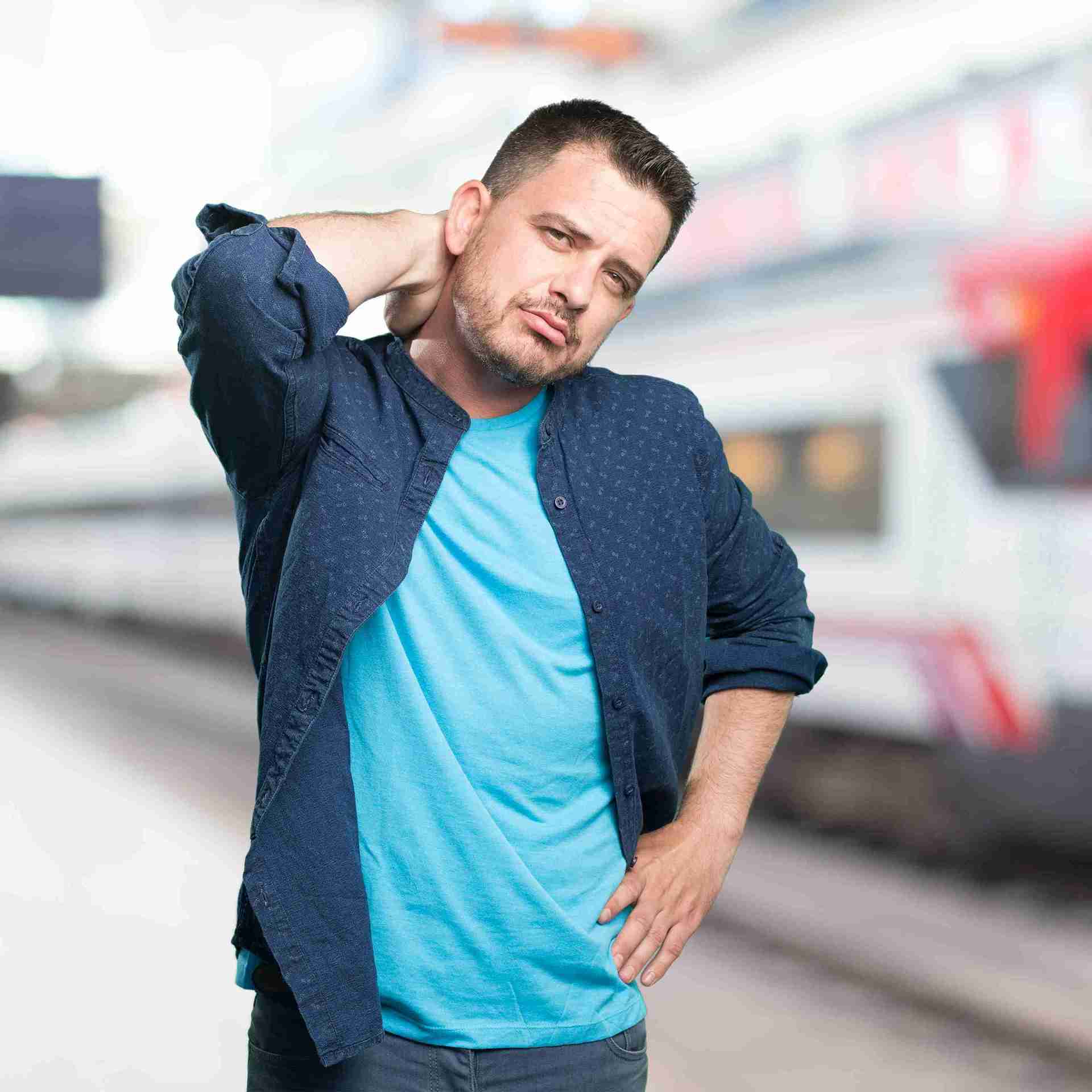 A young man holding his neck due to persistent discomfort and muscle strain.